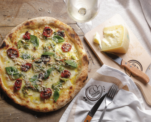 Pizza con zucchine al basilico e fiori, mozzarella fior di latte, pinoli di Migliarino, Pecorino Toscano DOP e pomodori confit
